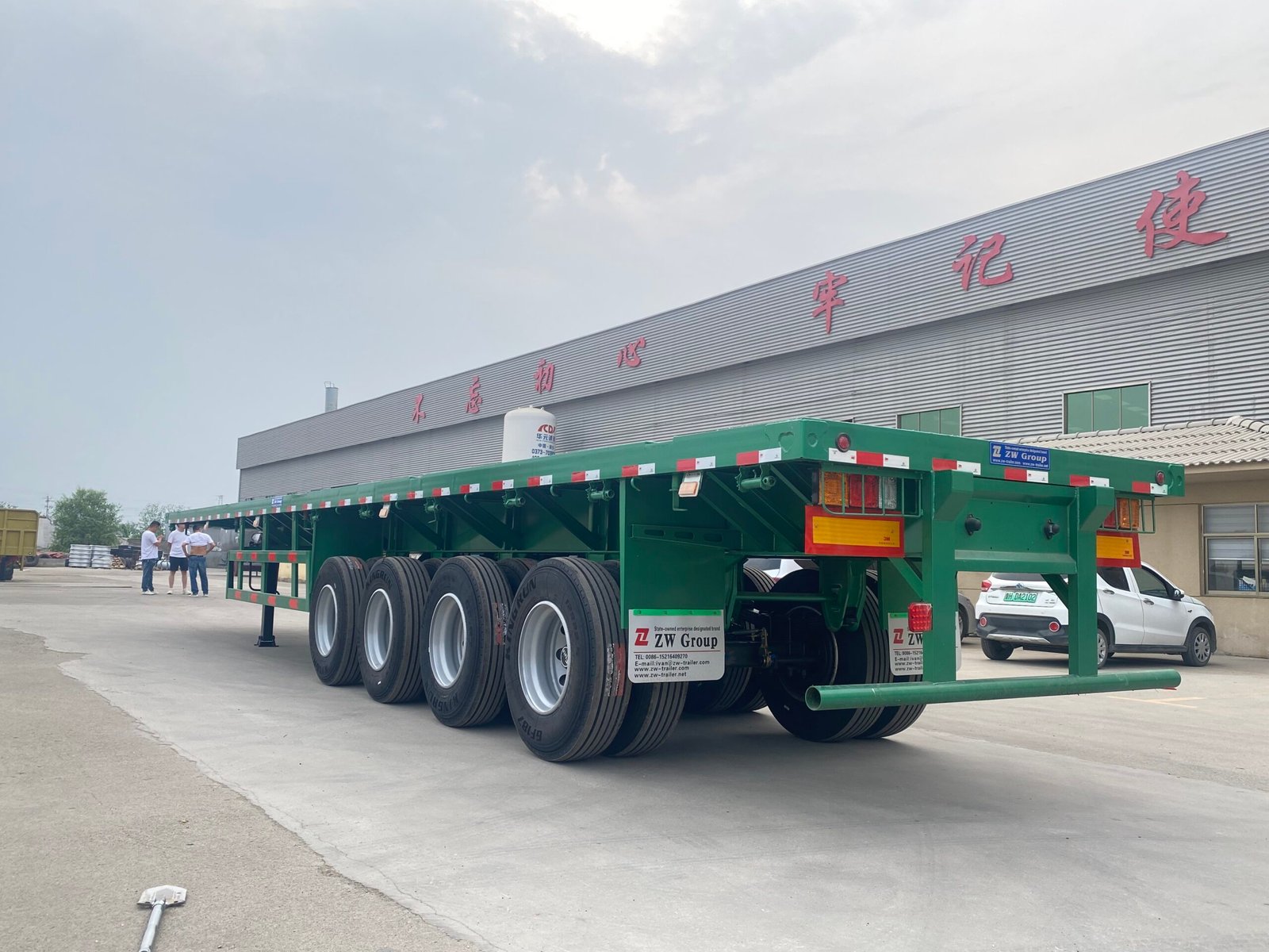 ZW Group 4-axle flatbed trailer front-side view with durable frame and container locks