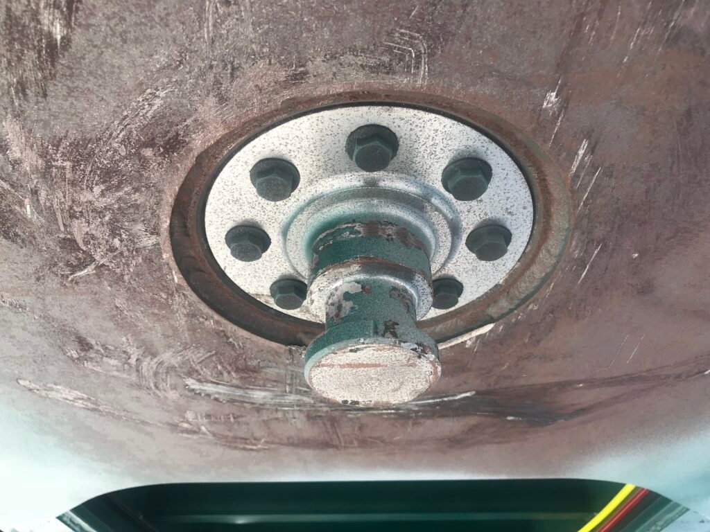 Heavy-duty king pin connecting trailer to tractor, ensuring secure towing
