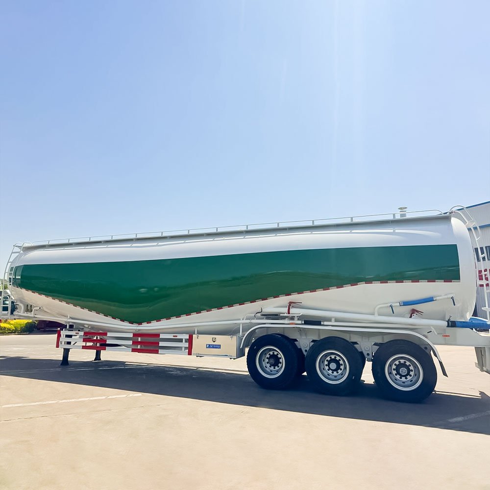 Cement bulk tanker trailer unloading dry cement on construction site