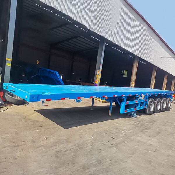 ZW Group 4 Axle 80 Ton Flatbed Semi Trailer transporting heavy machinery on a highway