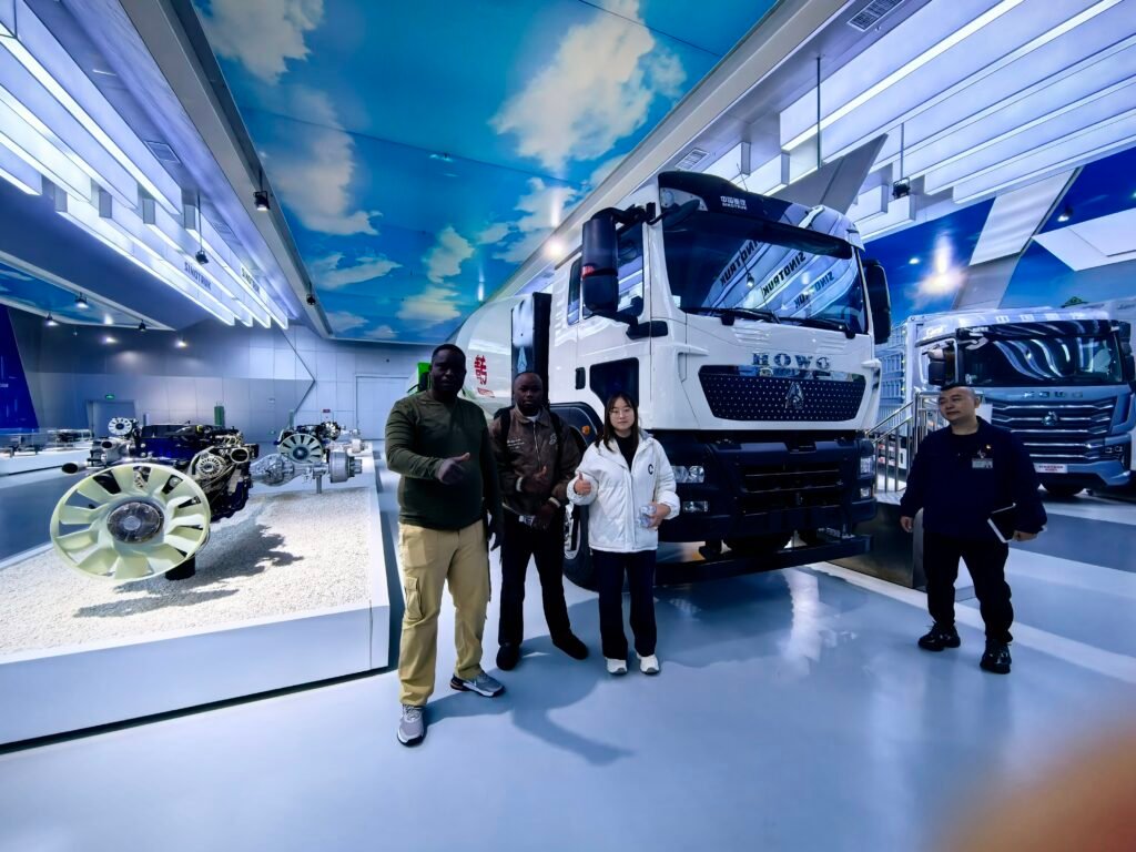Congo clients visiting SINOTRUK production workshop, inspecting HOWO truck assembly process