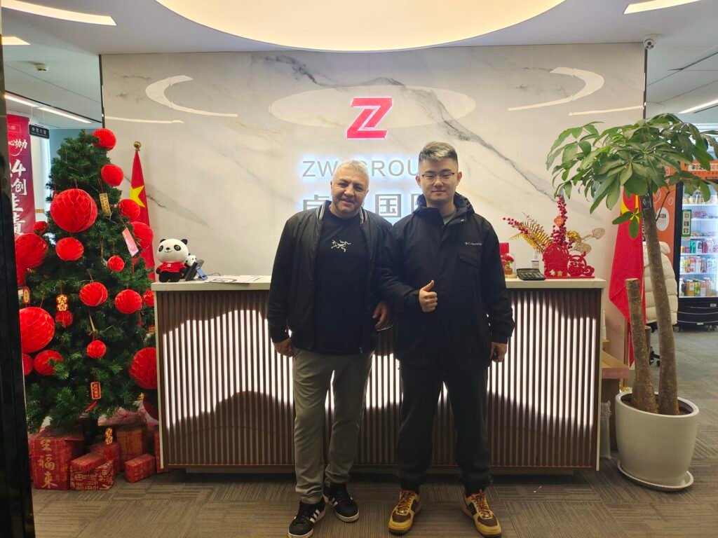 Lebanon clients and ZW Group team at factory entrance for Beiben truck and lowbed trailer order.