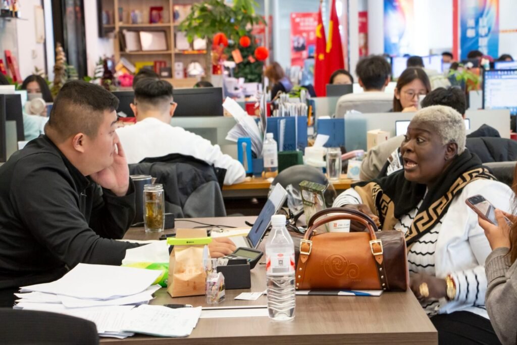 Nigeria client discussing rear dump semi trailer configuration with ZW team in office meeting