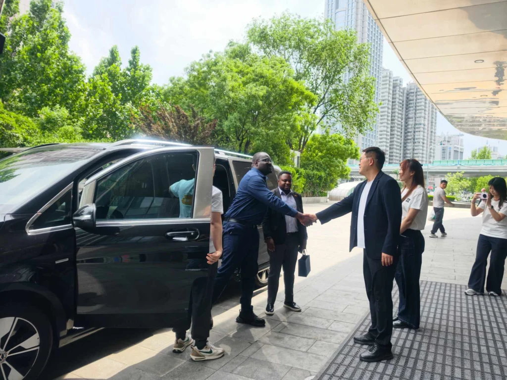 Ghana Embassy Minister-Counsellor Dr. Richmond Afotey Nii Okle shaking hands with ZW Semi Trailer Group Chairman Yongchang Sun in Jinan, China