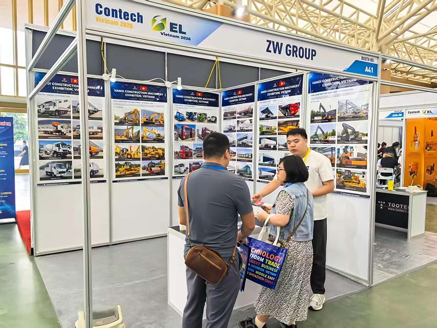 ZW Group representatives displaying semi-trailer and heavy equipment catalogs at Booth A41 during Contech Vietnam 2026.