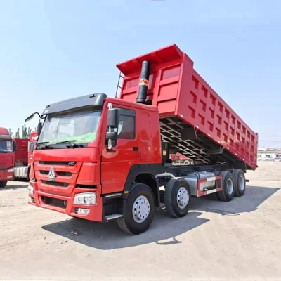 HOWO 420HP 8×4 red dump truck loading gravel at construction site
